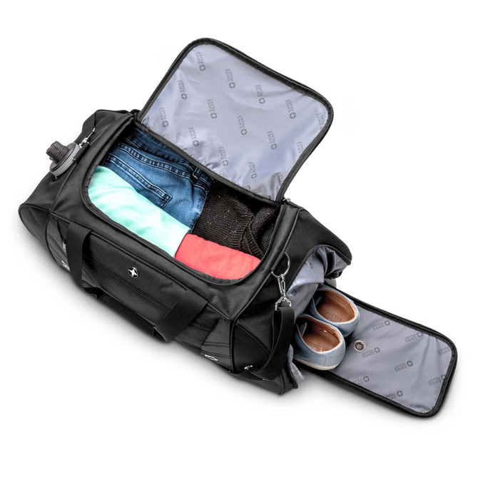 A black weekend or sport bag opened to reveal clothing and shoes inside, with a branded logo.