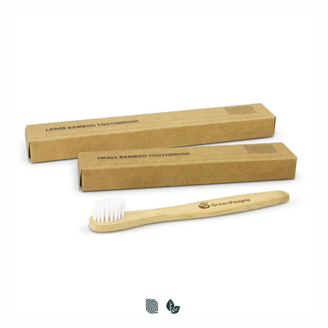 A bamboo toothbrush with a wooden handle and white bristles, accompanied by two brown cardboard boxes.