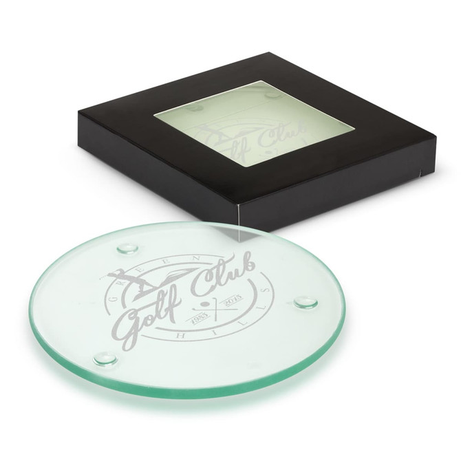A round glass coaster set in a black box, featuring a logo in grey on the surface.