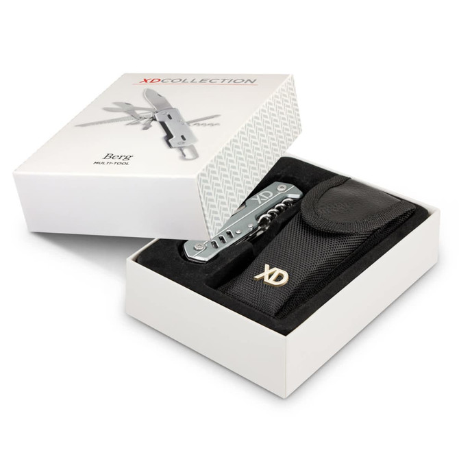 A multi-tool in a black pouch, presented in a white box. The tool has a silver finish and includes various functions.