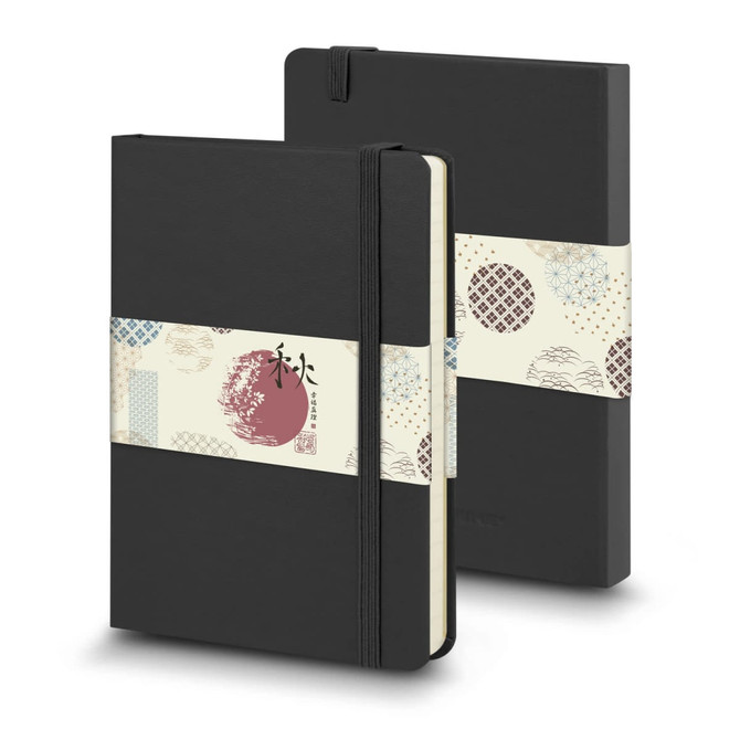 A large black hard cover notebook with an elastic band and decorative sleeve, featuring a logo.