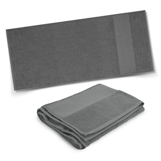 A dark grey bath towel displayed flat and another folded, featuring a subtle design and a logo.