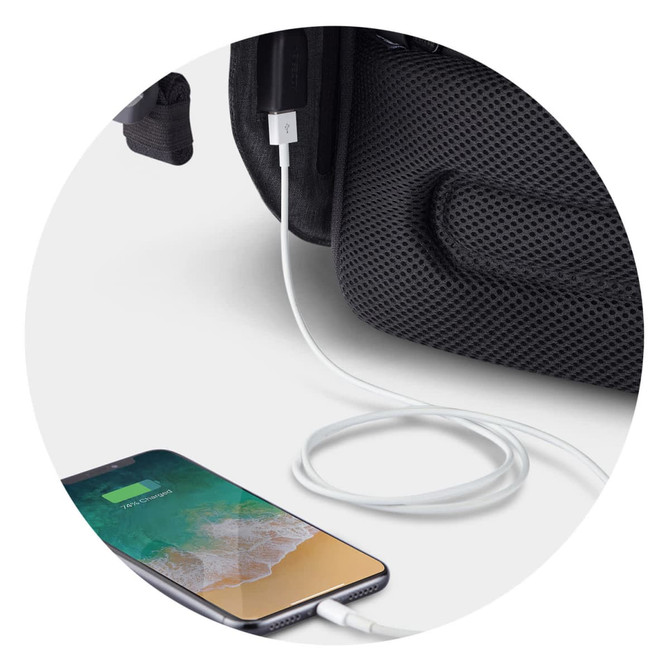 A black backpack with a cable connecting to a smartphone, showcasing a USB charging feature.