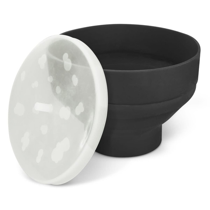 A black silicone microwave popcorn popper with a transparent lid featuring white spots.