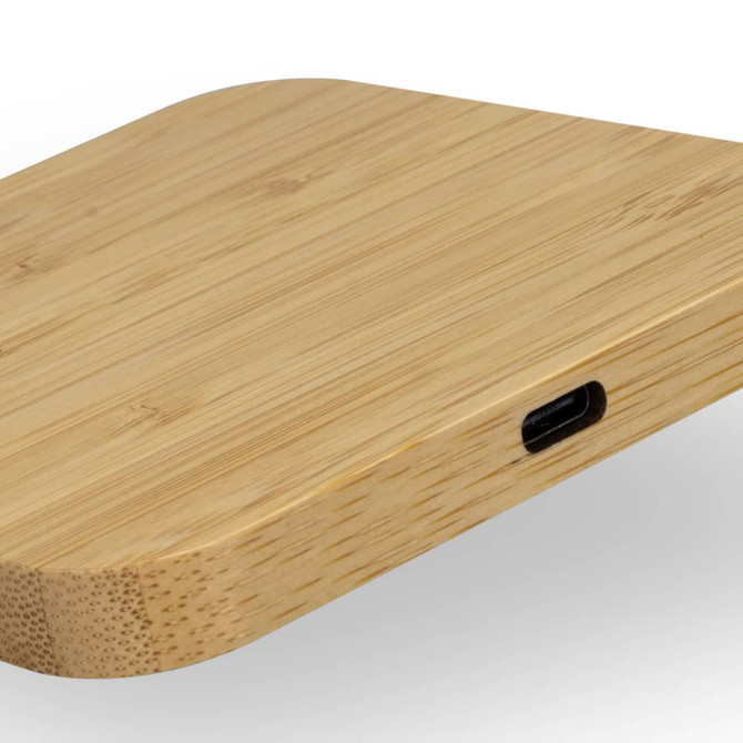 A bamboo wireless charging hub with a sleek, rounded design and a USB-C port.
