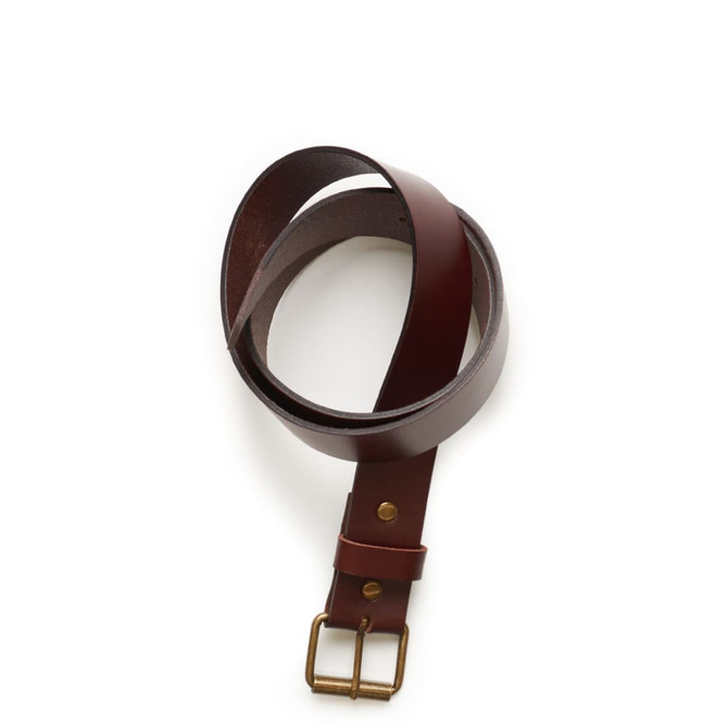 A brown leather belt with a brass buckle and fastening, coiled for display.
