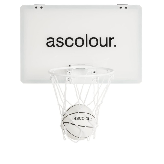 A mini basketball set featuring a white backboard, hoop, and a basketball with black detailing.