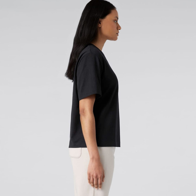 A black t-shirt displayed on a model from the side, featuring a simple design and relaxed fit.