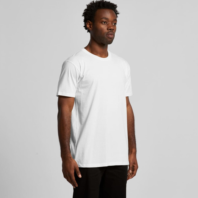 A white organic T-shirt worn by a model standing against a plain background. The shirt has a logo on it.