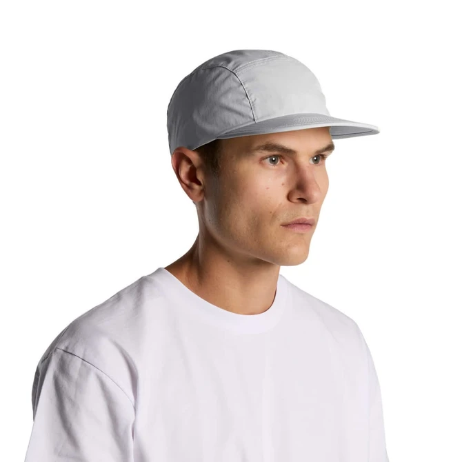A man wearing a light grey Finn Nylon Cap, paired with a simple white T-shirt. The cap features a branding logo.
