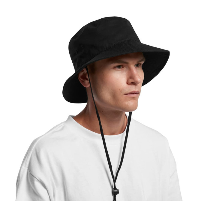 A black wide brim bucket hat with a chin strap, worn by a model in a white T-shirt.
