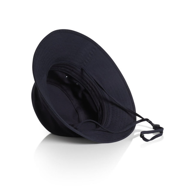 A navy nylon wide brim bucket hat with a drawstring and an inner lining. It features a logo.