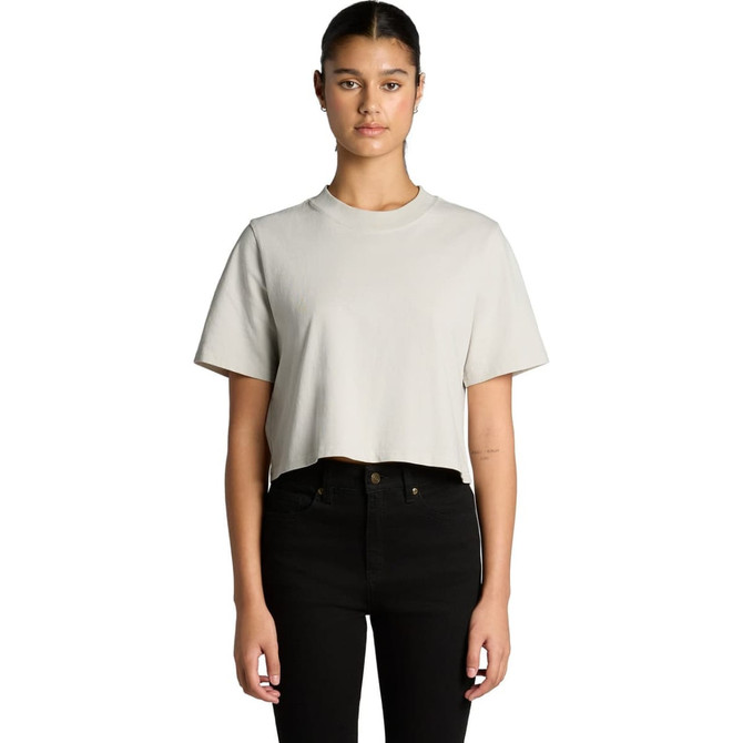 A cropped, heavy faded t-shirt in light grey, displayed on a model with black jeans. The shirt has a logo.
