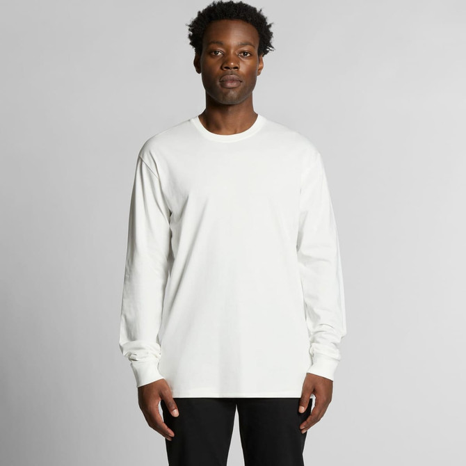 A long-sleeve, organic t-shirt in white, featuring a logo, modelled by a person against a plain background.