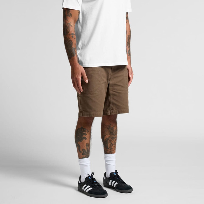Canvas shorts in a brown shade, featuring a relaxed fit and cargo-style pockets, paired with a plain white T-shirt and black sneakers.