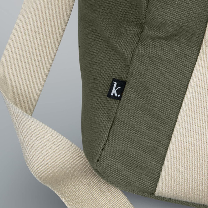 A green cooler bag features a light fabric strap and a small logo tag on the side.
