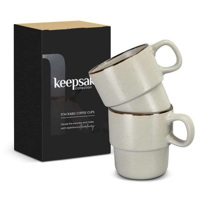 A stack of two light grey coffee cups with dark rims, packaged in a branded box.