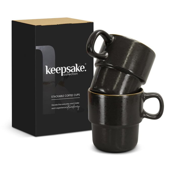 A set of two black stackable coffee cups displayed in a box, featuring a logo on the front.