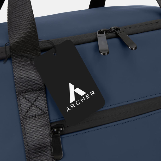 A soft-touch cooler bag in navy blue with a black tag and zippered compartments. The bag features a logo.
