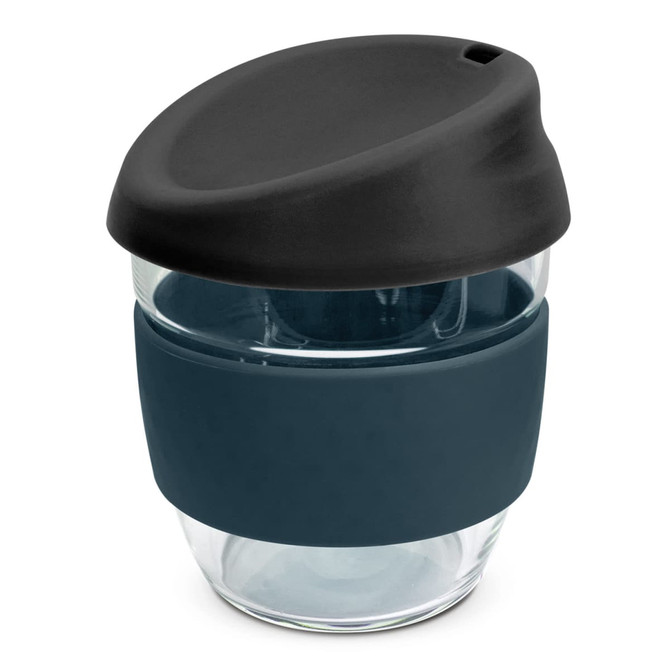 A drink bottle with a dark blue silicone sleeve and a black lid, made of clear borosilicate glass.