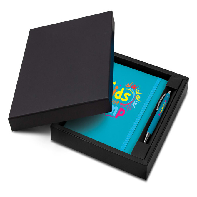 A blue notebook and pen set displayed in a black gift box. The notebook features a logo and the set includes branding on the pen.