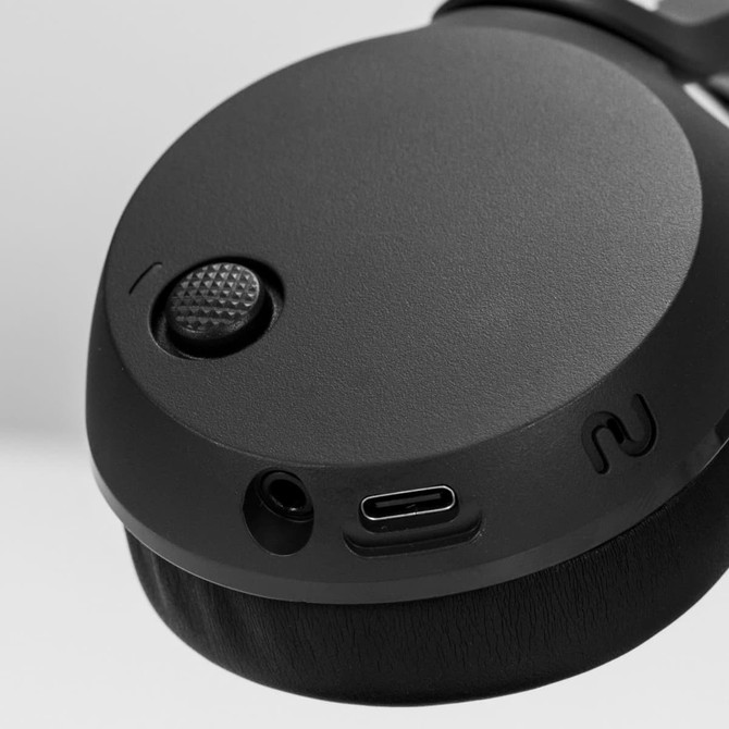 A close-up of black Skullcandy Icon 180 Wireless Headphones, highlighting the control buttons and charging port.