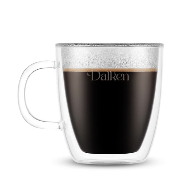 A double wall mug made of clear glass, filled with dark liquid, featuring a handle and a logo.
