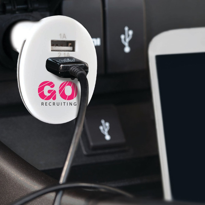 A white USB car charger with a cable connected, fitted into a vehicle's port, featuring a logo.