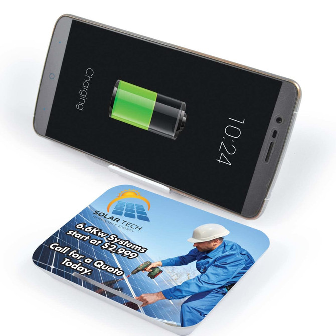 A wireless charger with a sleek design and a smartphone on top displaying a battery charging icon.