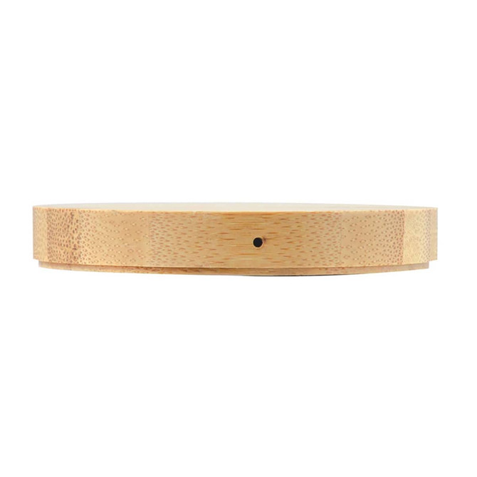 A round bamboo wireless charger with a smooth surface and a subtle logo, showcasing its natural wood texture.