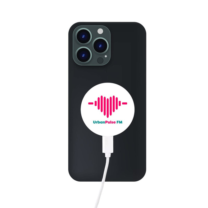A black smartphone with a circular white magnetic wireless charger attached, featuring a logo design.