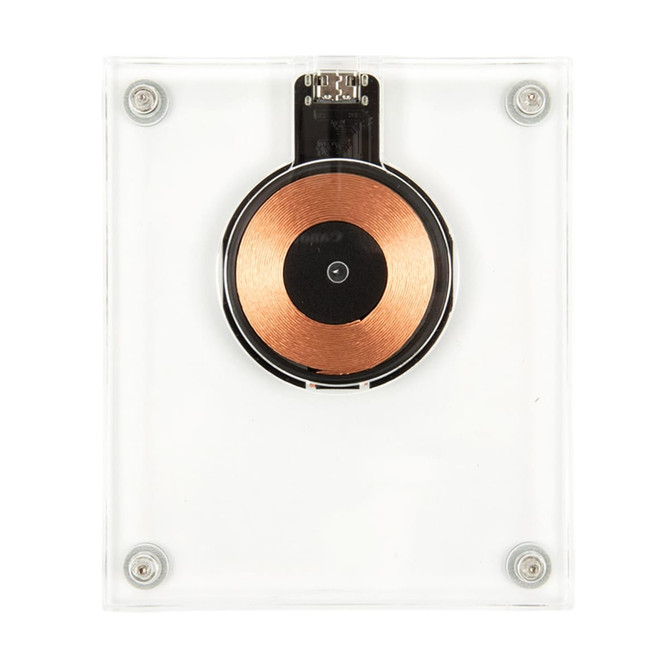 A crystal wireless charger with a clear casing and a circular copper charging pad in the centre.