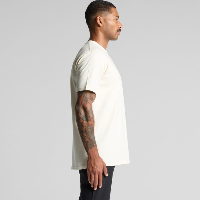 A side view of a light cream short-sleeve classic tee t-shirt with a simple design and a logo.