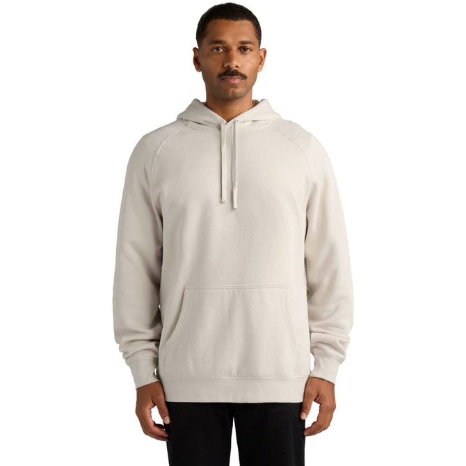 A beige hoodie with a front pocket and drawstring hood, worn by a man standing upright. It features a logo on the side.