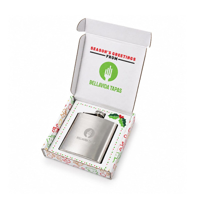 A hip flask in a festive box featuring a logo, with a silver finish and holiday-themed packaging.