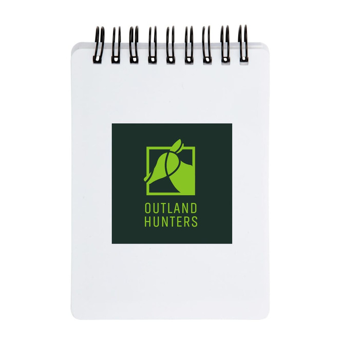 A spiral-bound pocket notebook with a white cover featuring the logo of "Outland Hunters" in green and black.