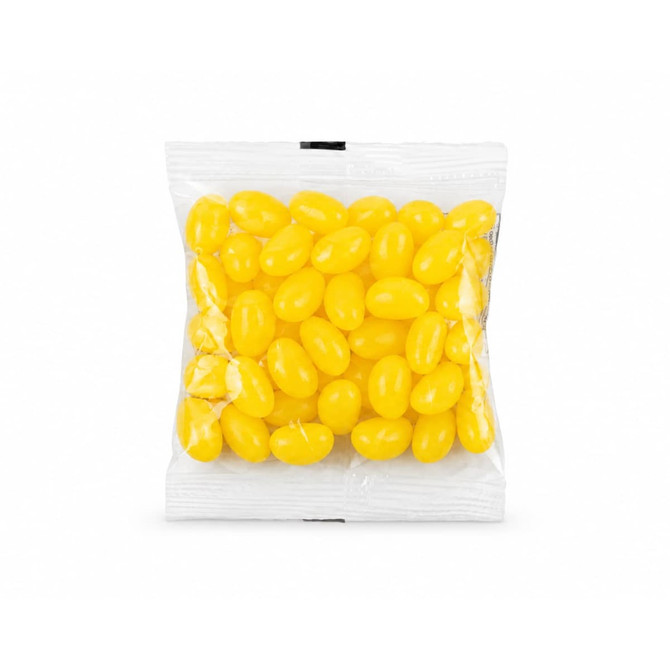 A clear cello bag filled with bright yellow jelly beans. The bag is sealed and contains various shaped candies.