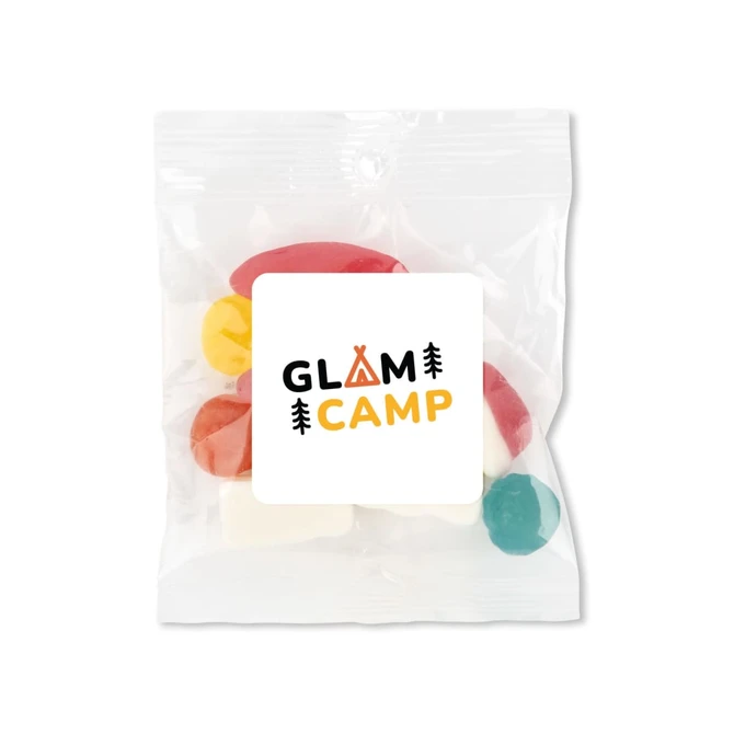A clear plastic bag containing colourful candies, featuring a label with a logo.