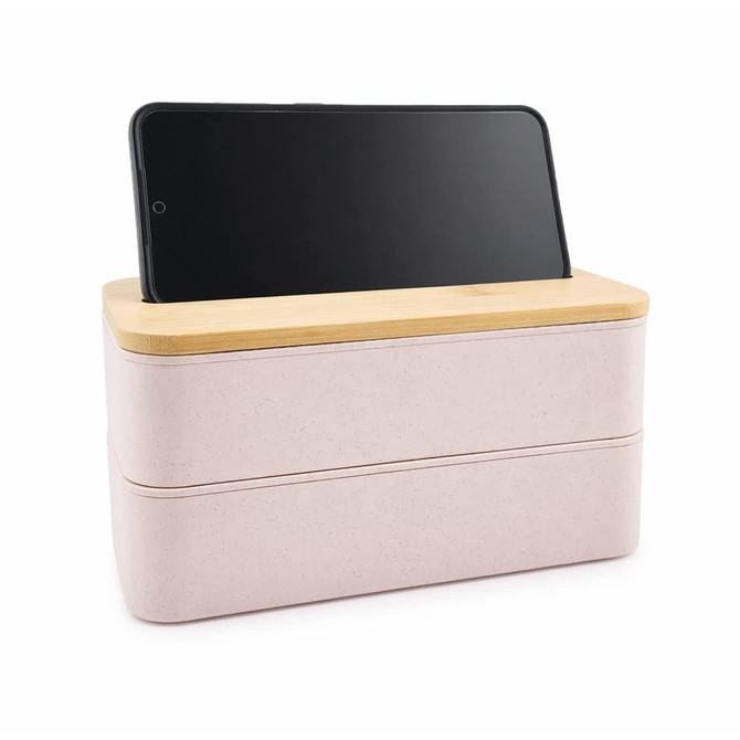 A pink eco lunch box with a bamboo lid and a phone holder, featuring a simple and modern design.