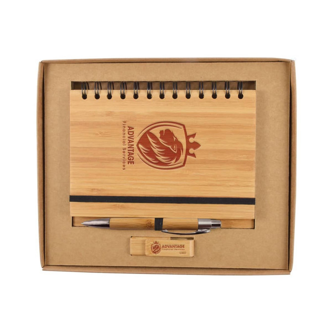 A bamboo notebook with a spiral binding, a pen, and a wooden USB drive, all presented in a cardboard gift box.