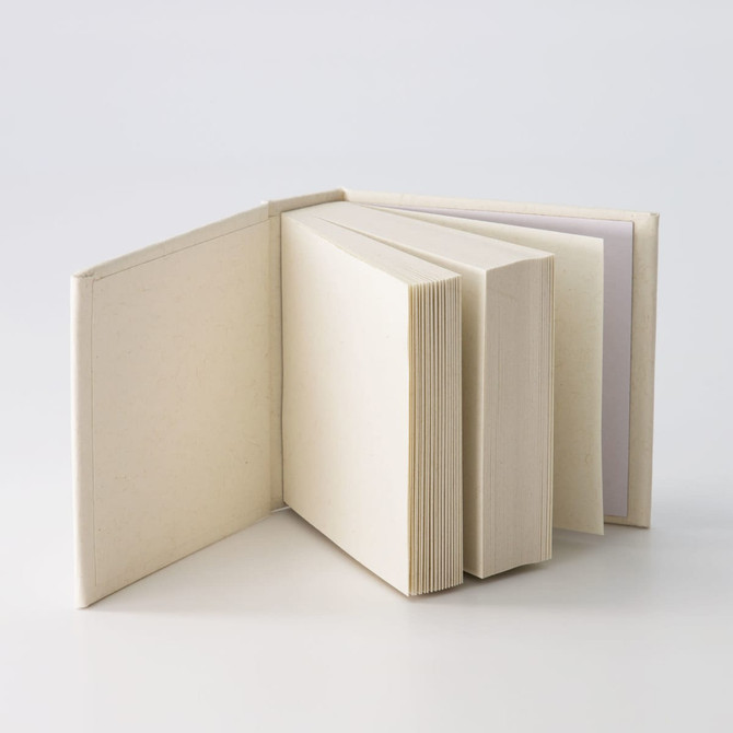 A tower note block featuring multiple stacks of blank pages in a neutral colour, with a simple, unbranded design.