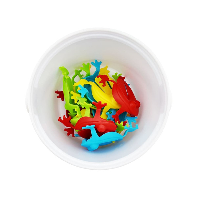 A white bucket containing colourful plastic frogs in red, yellow, green, and blue.