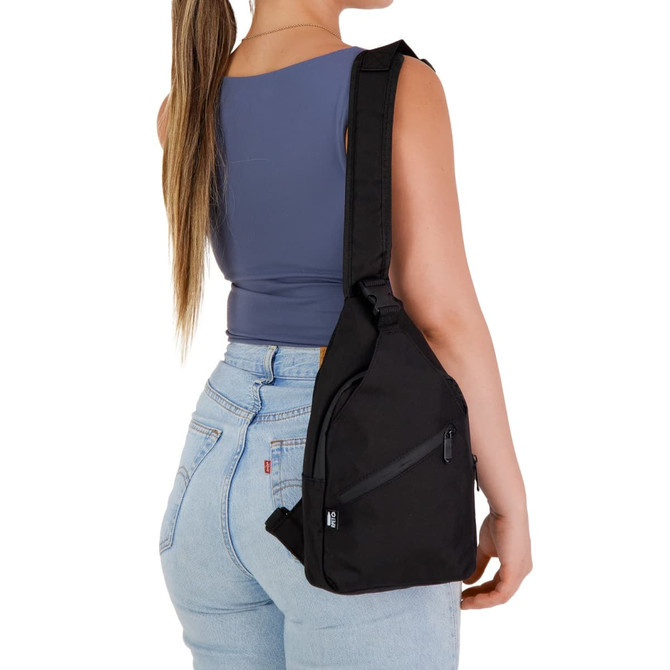 A sleek black wallaby neck pouch is worn over the shoulder, featuring a zippered pocket and adjustable strap.