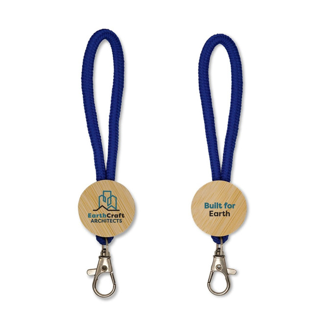 A keytag with a wooden circular base, featuring a logo and attached to a blue braided lanyard.