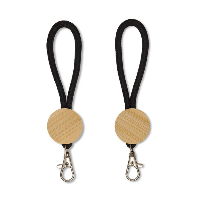 A keytag featuring a round wooden element with a black rope attachment and a metal clip.
