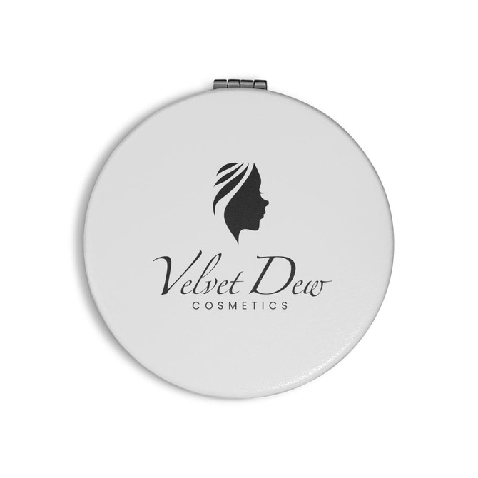 A round white compact mirror featuring a logo and an elegant design of a woman's profile.