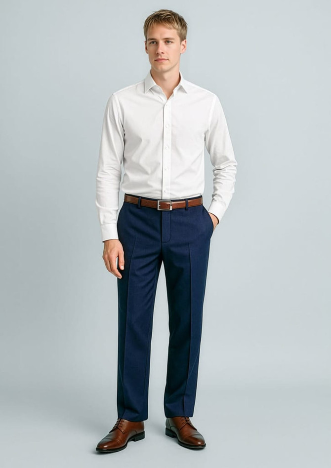 A man wearing a white shirt and navy blue flat front slacks, with a leather belt and shoes, standing against a light background.