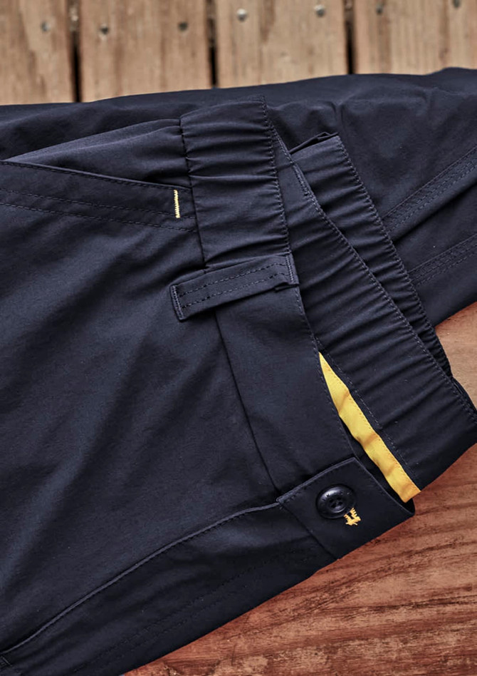 Lightweight men's outdoor cargo pants in black, featuring a button closure and elastic waistband, with a logo present.