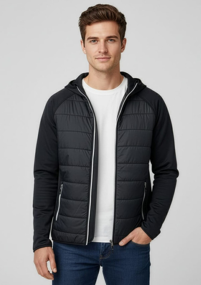 A man wearing a black puffer jacket with a hood, paired with a white t-shirt and blue jeans. The jacket has a logo.