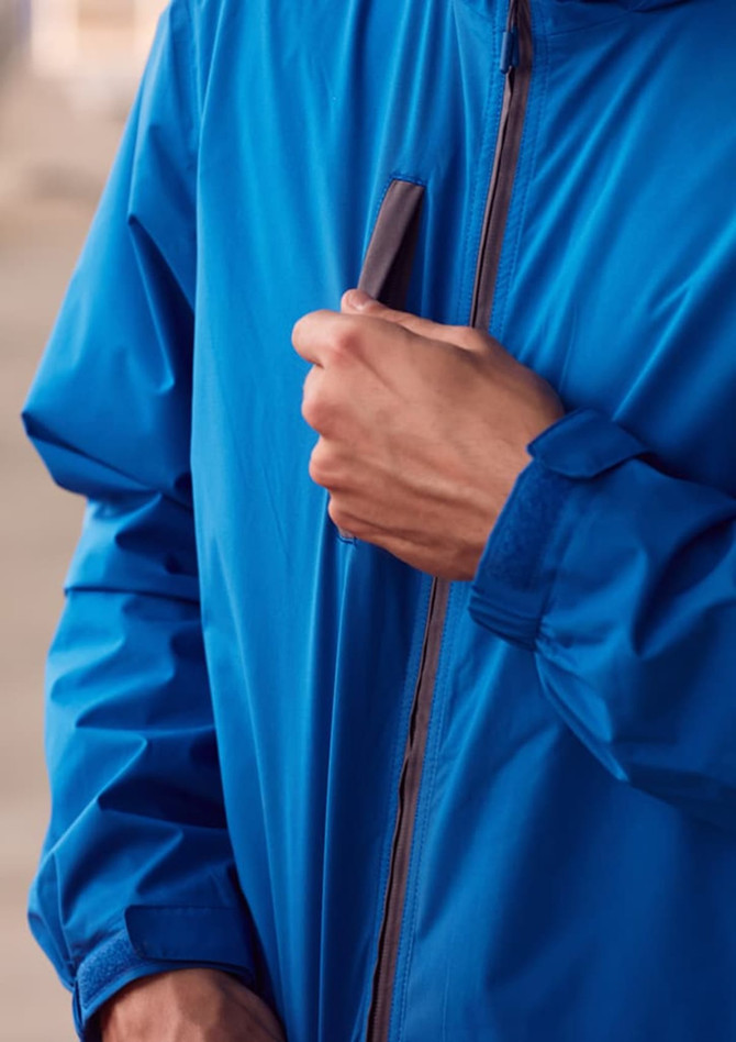 A blue unisex super light packable rain jacket with a zip and a logo on the chest.